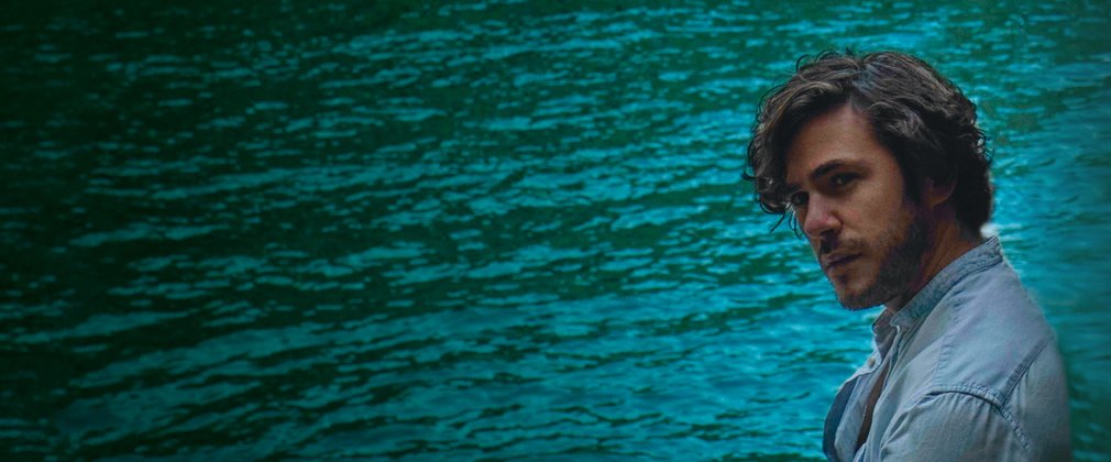 Singer, Jack Savoretti poses in front of a lake