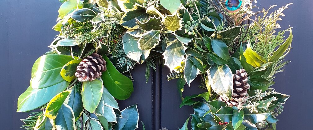 A handmade Christmas wreath hung on a door