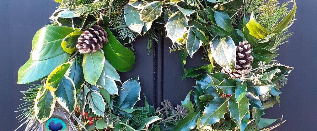 A handmade Christmas wreath hung on a door