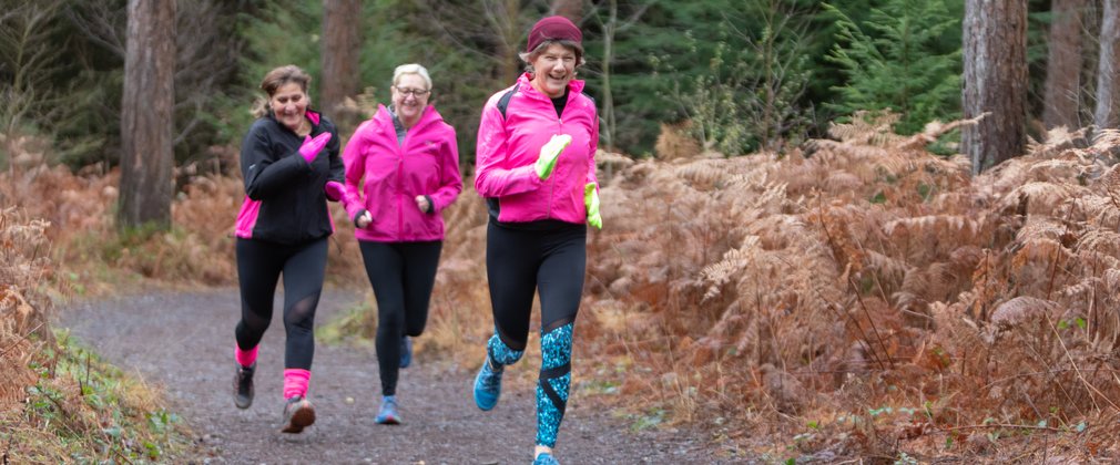 women running in forest