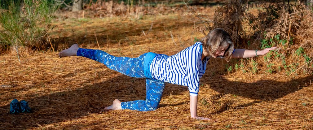 Woman doing Pilates pose in the forest