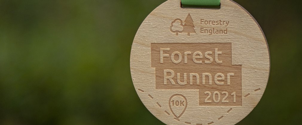 Forest Runner 2021 wooden medal on green ribbon