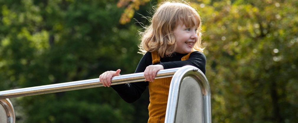 child playing on play equipment