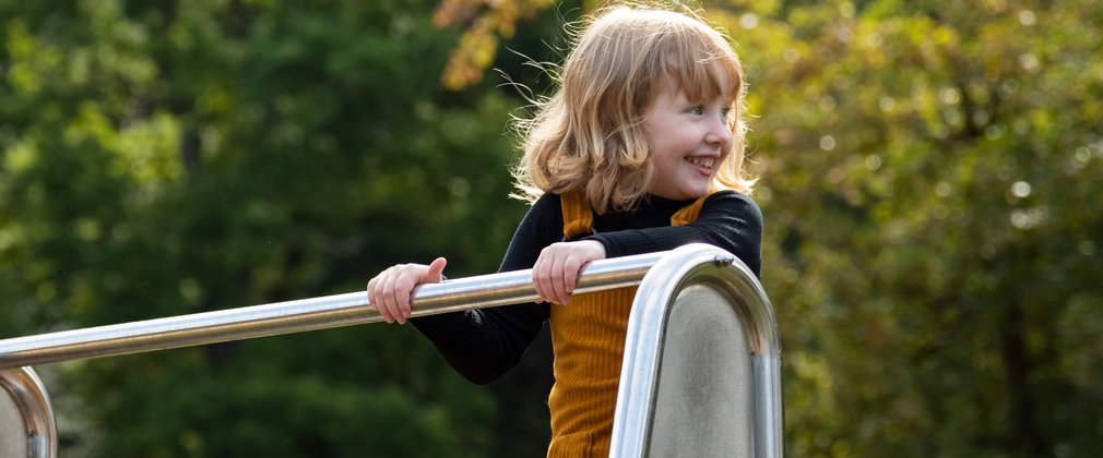 child playing on play equipment 