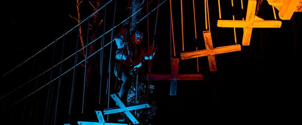 Person doing a forest climbing activity at night