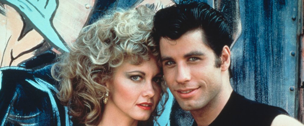 John Travolta as Danny Zuko and Olivia Newton John as Sandy Olsson in Grease.