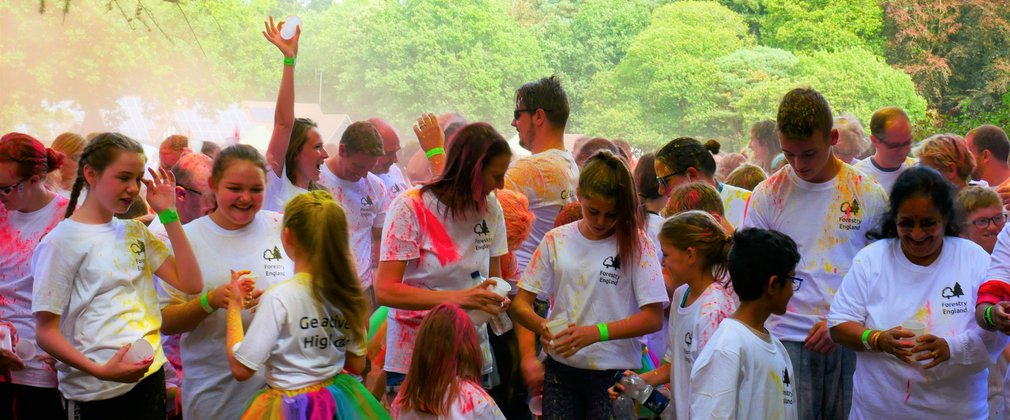 Group of people at colour run throwing powder paint