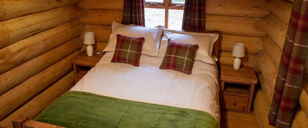 A double bed insite a log cabin