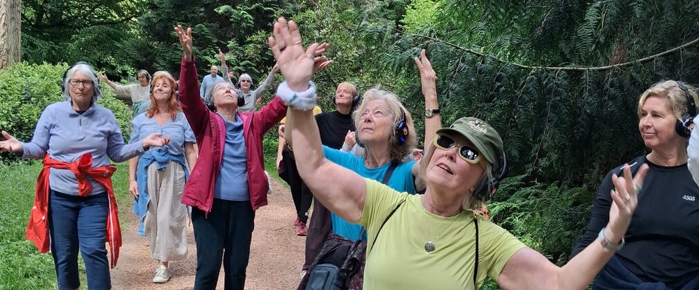 A group of people dancing in a forest