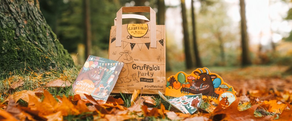 paper party bag and stickers on a forest floor