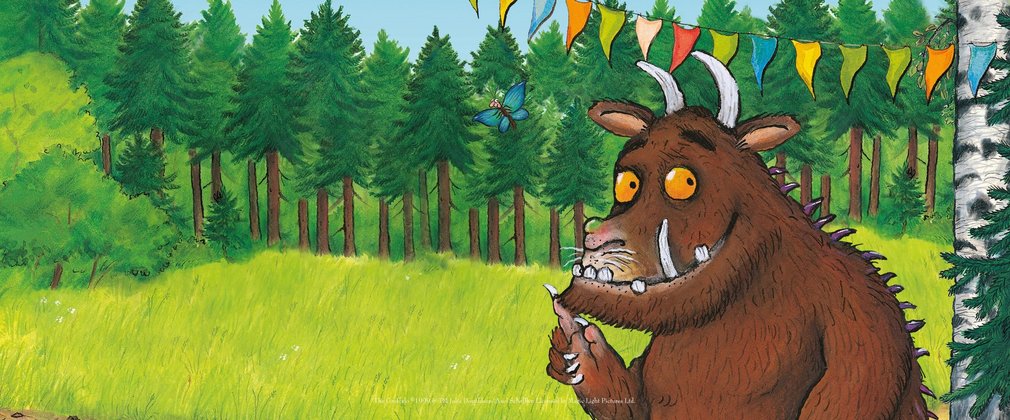 Gruffalo standing under a party banner 