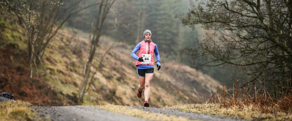 Runner on forest trail 