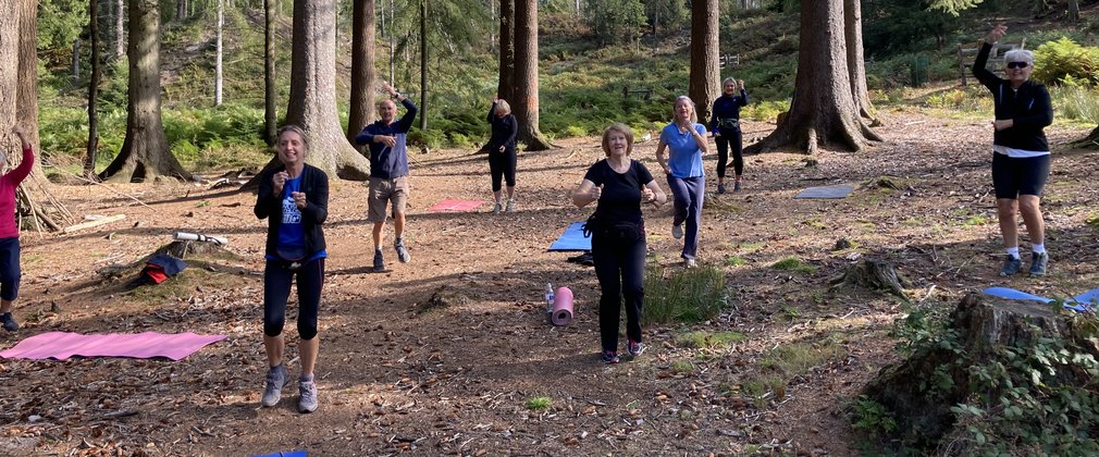 Fit4life Forest Fitness group of people exercising under the trees