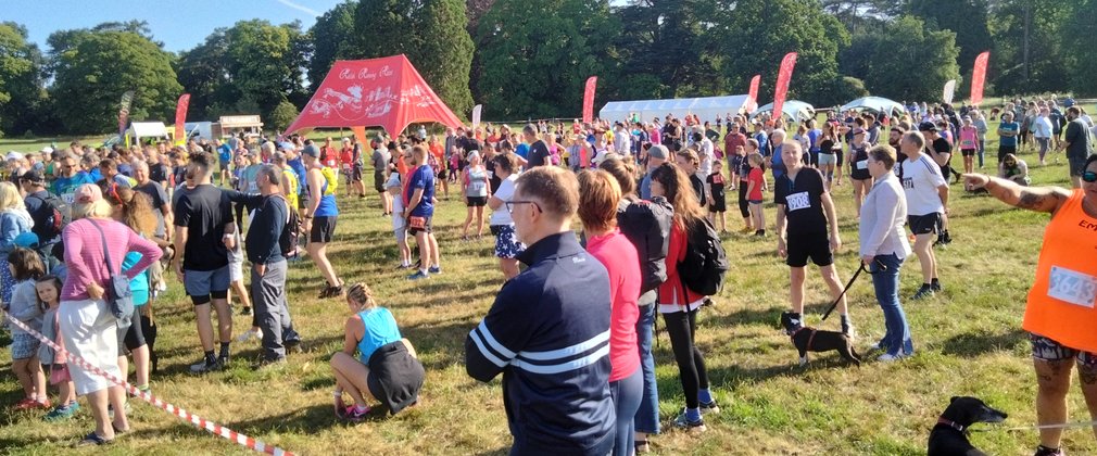 Spectators and runners get ready for a run in the trees