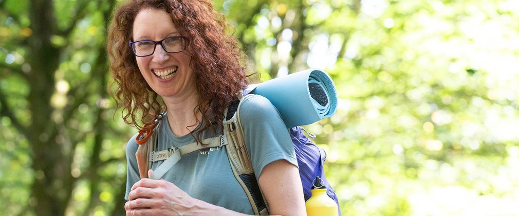 Women in forest smiling