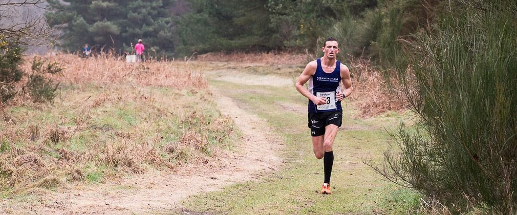 Man running on forest path