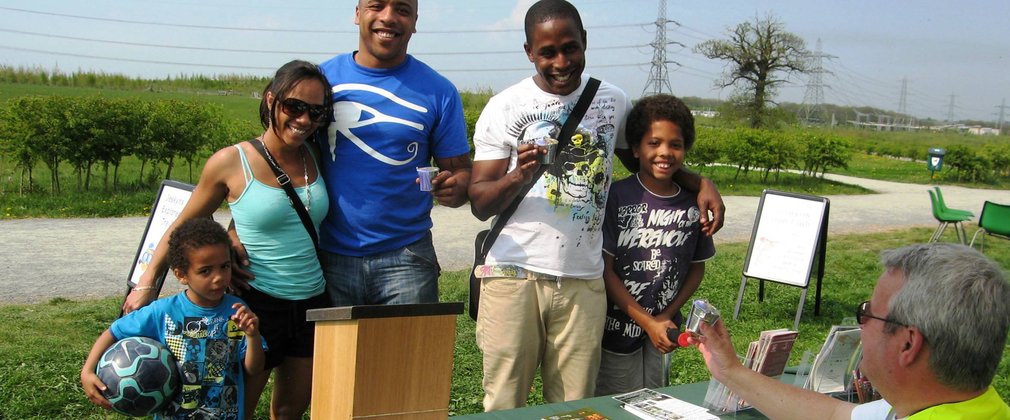 Family looking at leaflets at a stall in an outdoor event