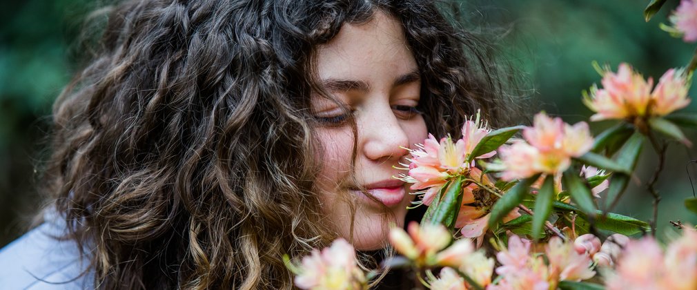 Girl smelling flower