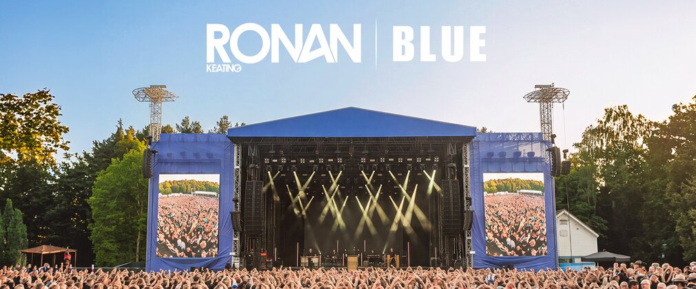 A blue stage with logos for Ronan Keating and Blue