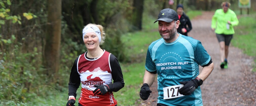 Couple running in the forest