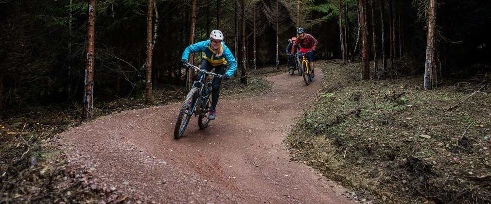 Female mountain bike rider on a forest trail