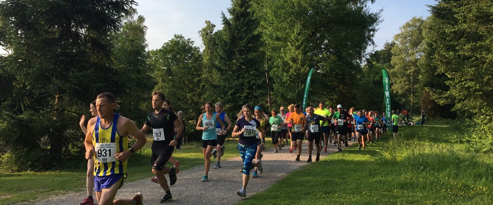 At the start of the race, people running through trees