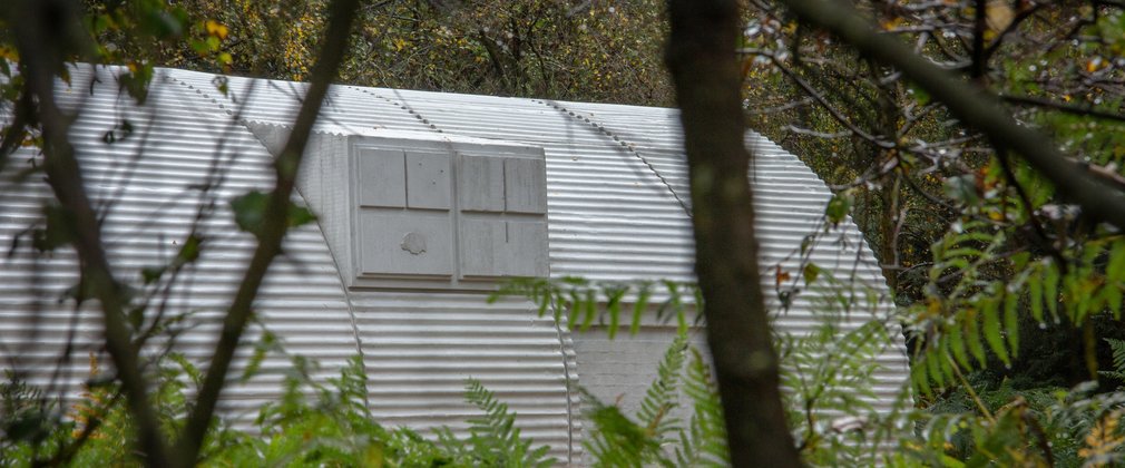 Nissen Hut sculpture through the trees