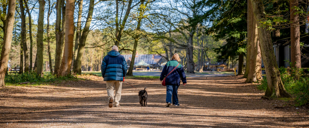 Older couple walking near carousel at High Lodge