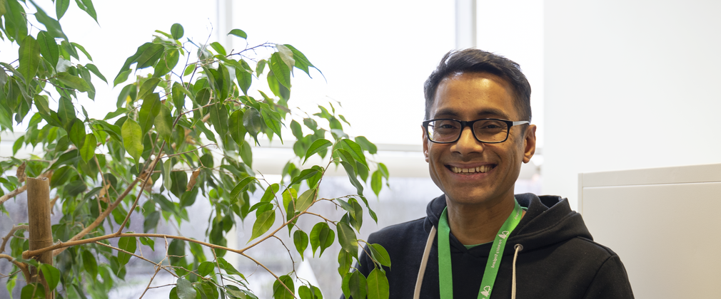 Forestry England staff member stood by tree smiling