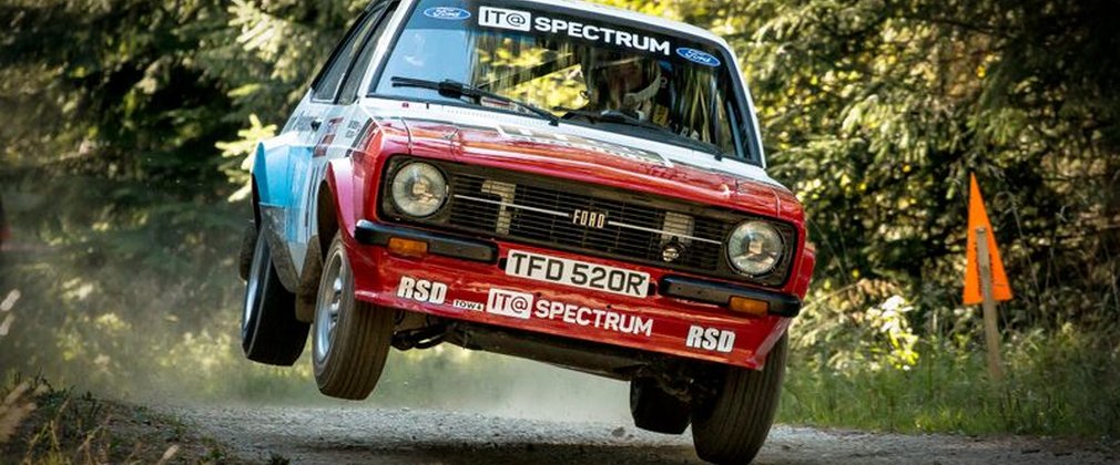 Car flying through the air at track racing event