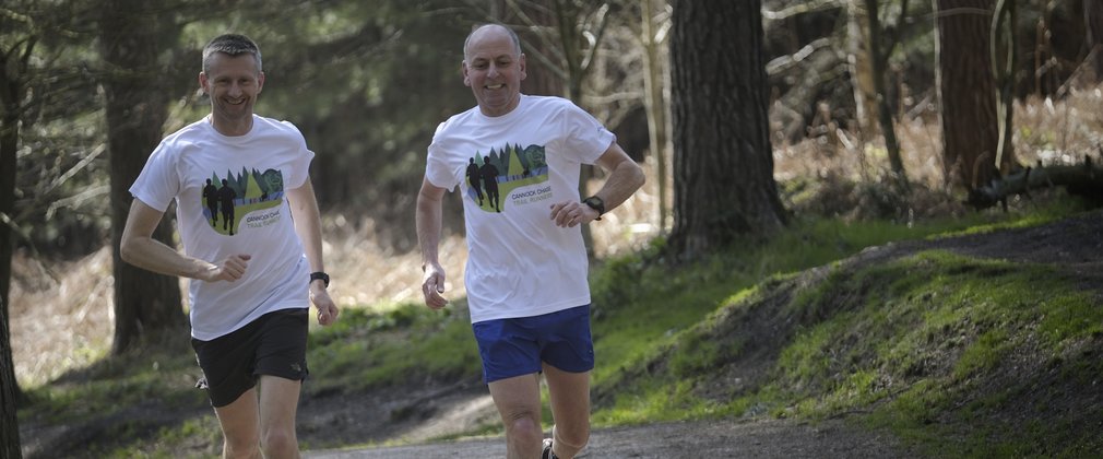 Two men running in the forest