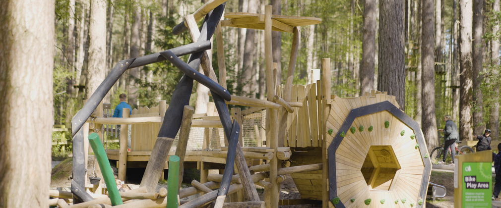 Wooden play structure where the different parts make up a representation of a bicycle