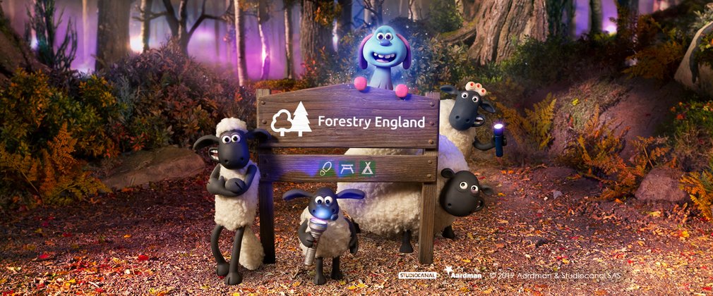 Shaun the Sheep, Lu-La and friends surroudn a Forestry England sign