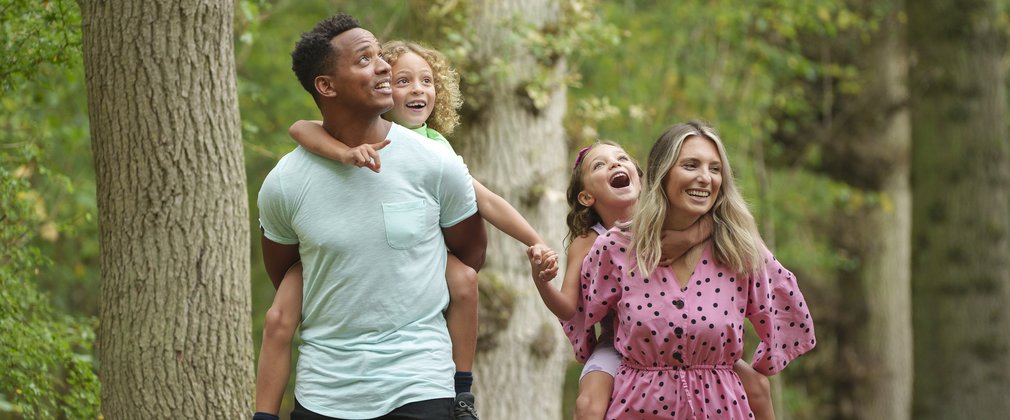 A family of four walking in Salcey Forest