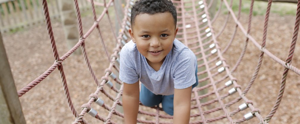 Child playing on rope bridge