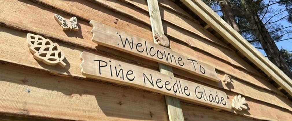 A sign on the front of a shelter explaining the name of the building