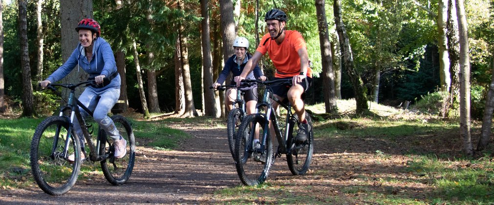 A family cycling in the spring at Alice Holt Forest