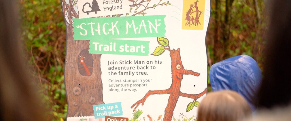 A branded Stick Man panel in the forest