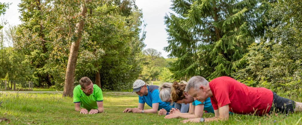 Group of people exercising in the forest
