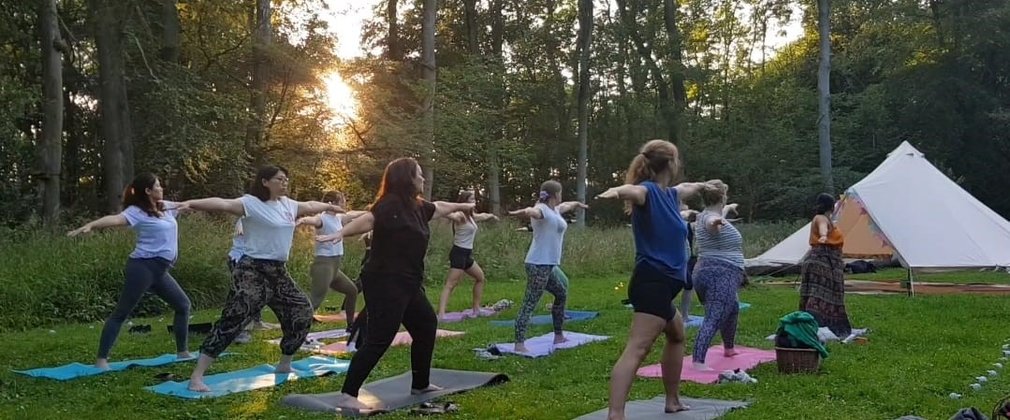 Group of people practicing yoga in the forest
