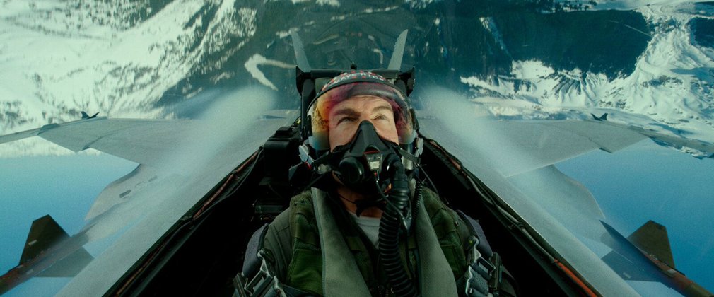 Maverick, played by Tom Cruise, performs a maneuver in a fighter jet plane. 