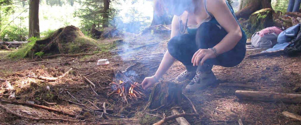 Woman lighting fire bushcraft