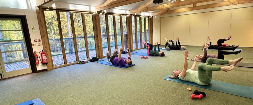 A group of people taking part in a pilates class