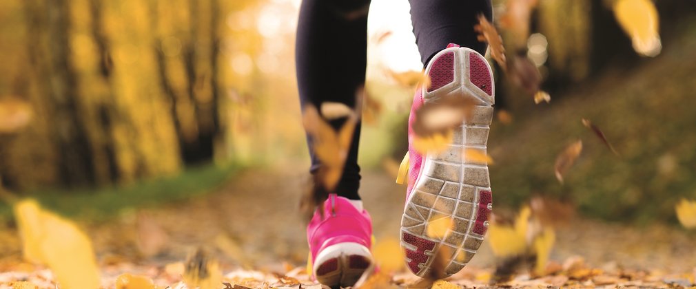 runner in autumn through woodland