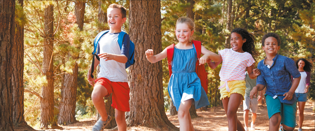 Children running through the forest