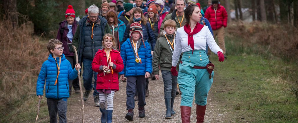 Theatrical captain leading a group of visitors