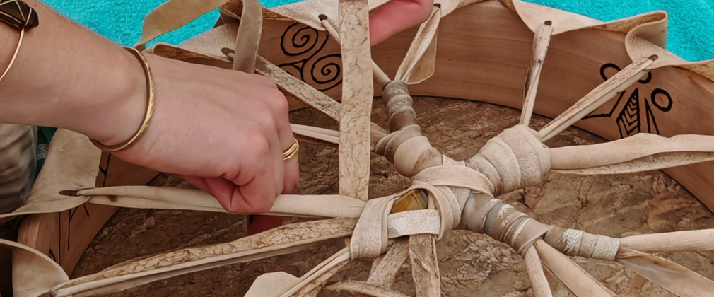 Close up of a hand binding and making a drum