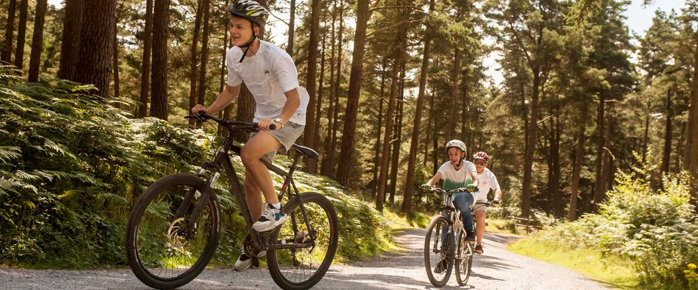 Three young people cycling