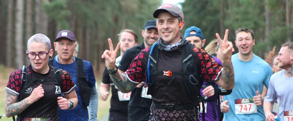 runners pose for a photo whilst running