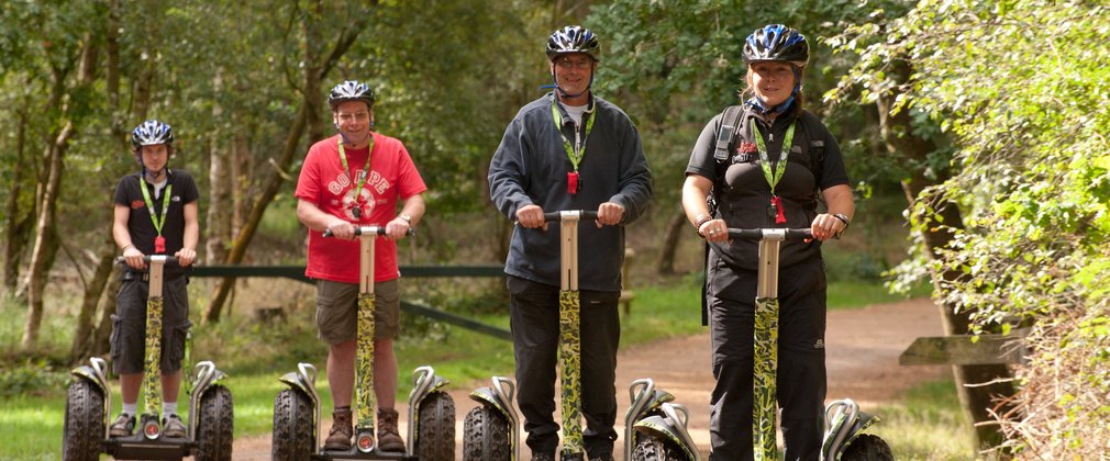 Segway users on a forest trail